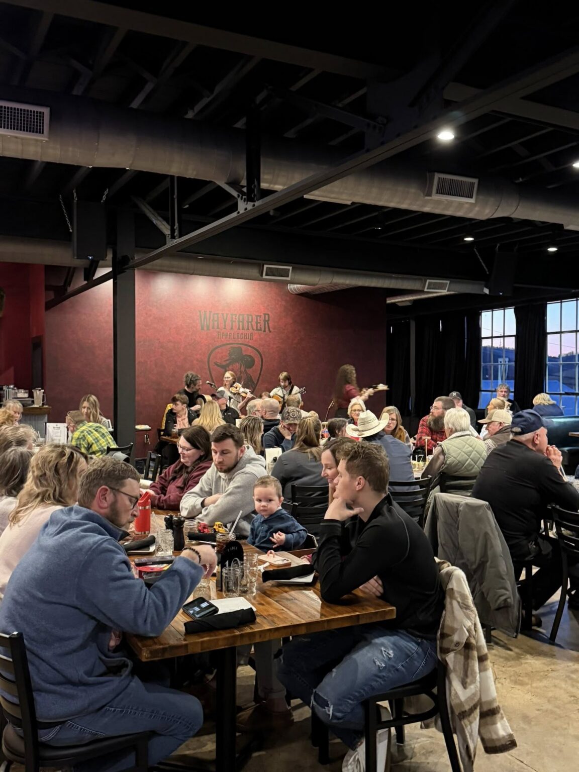 a group of people having a fun dining experience and concert visit in tazewell va near back of the dragon brewery